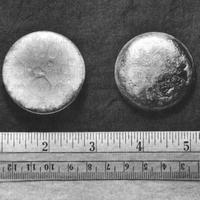 Plutonium pictured against an inch and centimeter rule.